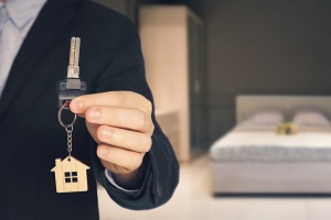 person holding up keys to apartment